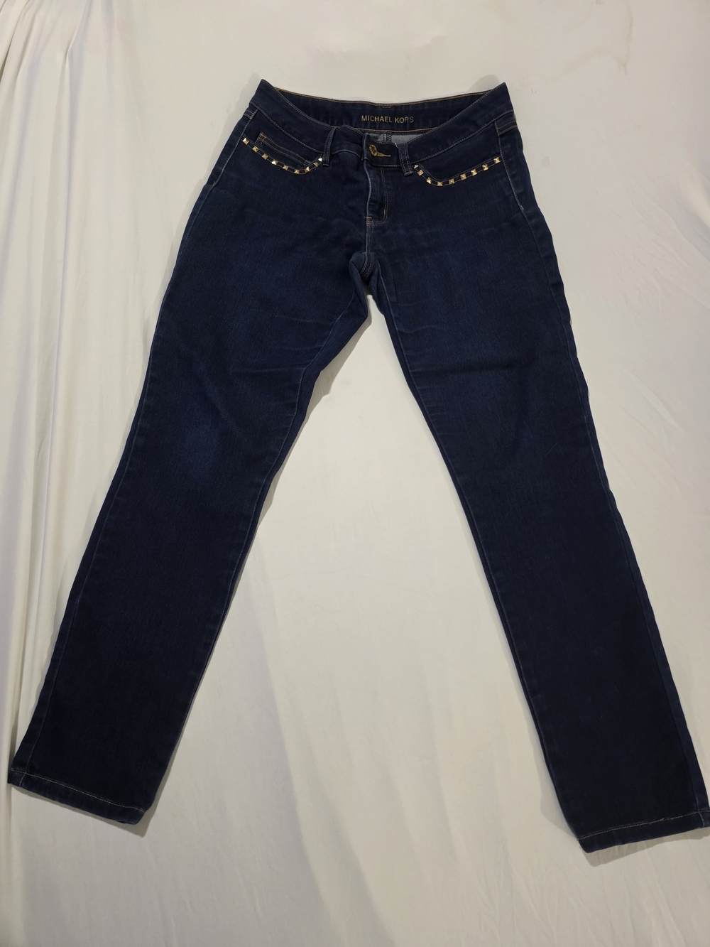 Stylish dark wash jeans by Michael Kors featuring gold stud detailing along the